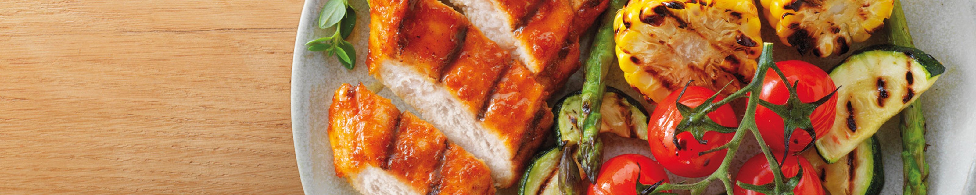 Sliced BBQ chargrilled chicken with grilled corn, courgette, asparagus and tomatoes